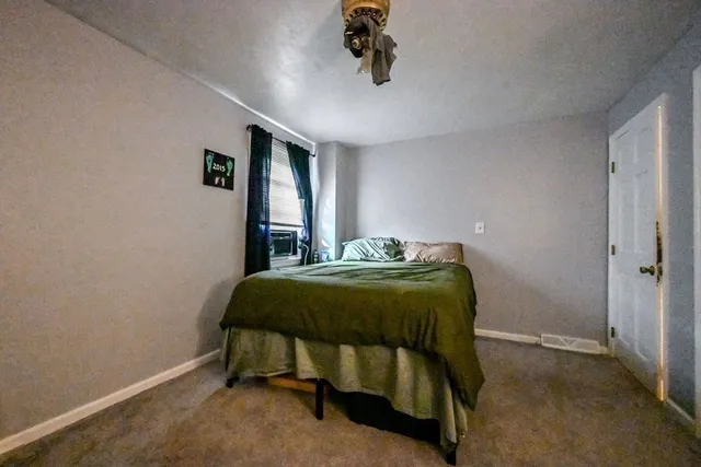 a bedroom with a bed and a chandelier