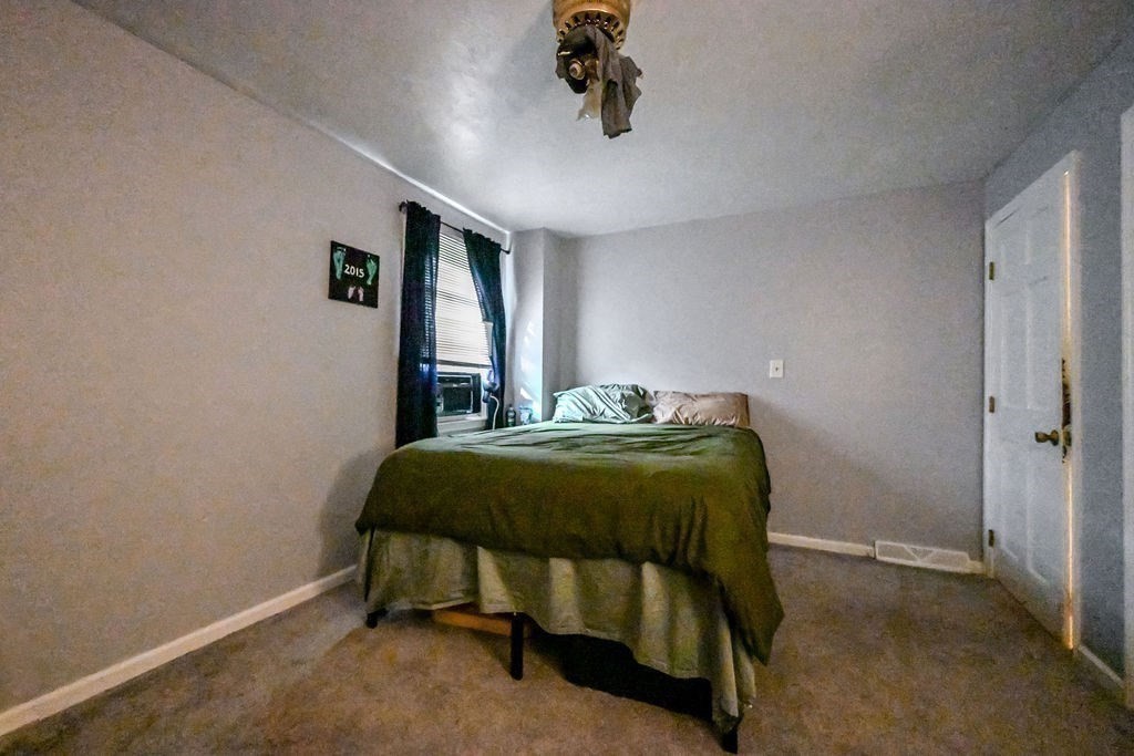 9 Lawrence Road Plymouth, MA 02360 - Photo 12 of 30 a bedroom with a bed and a chandelier