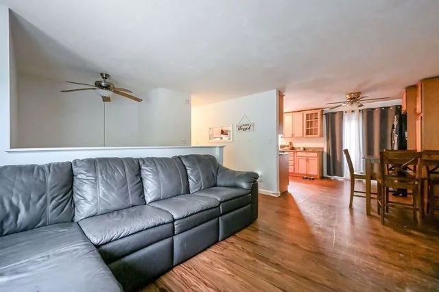 a living room with furniture and a wooden floor