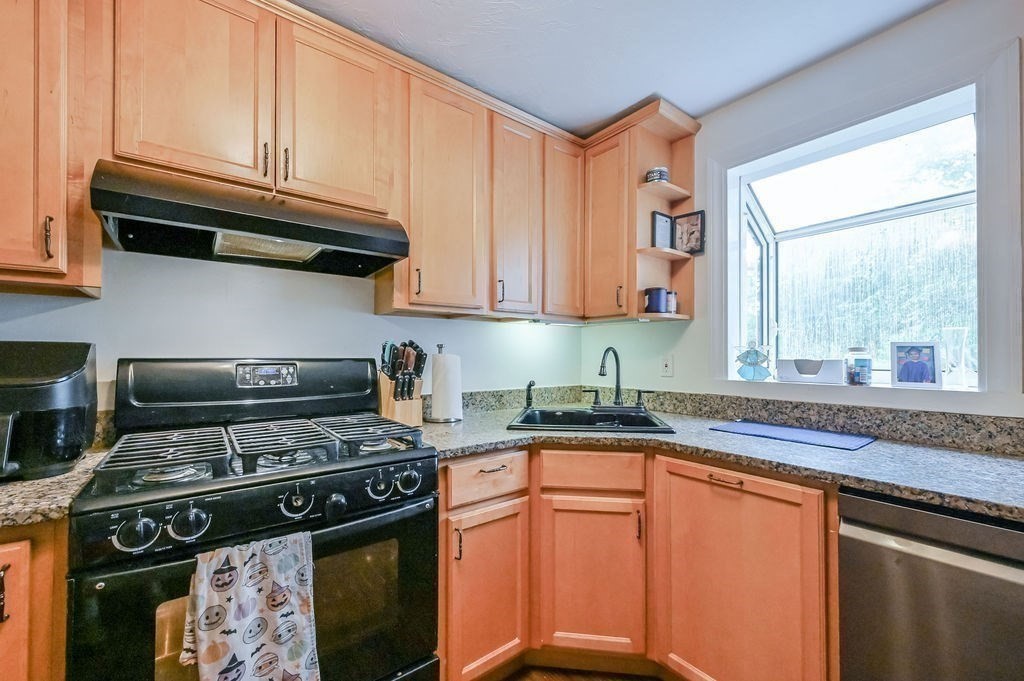 9 Lawrence Road Plymouth, MA 02360 - Photo 6 of 30 a kitchen with stainless steel appliances granite countertop a stove a sink and a microwave