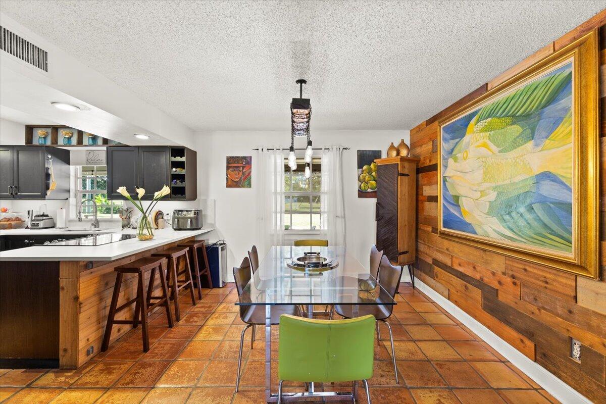 3179 Hoy Lake Road Wellington, FL 33467 - Photo 11 of 43 a living room with stainless steel appliances furniture a chandelier and a view of kitchen