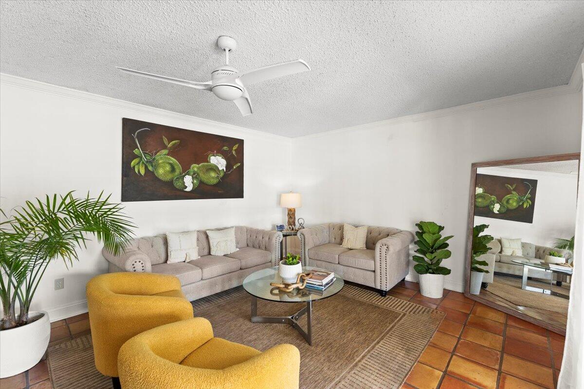 3179 Hoy Lake Road Wellington, FL 33467 - Photo 14 of 43 a living room with furniture and a painting on the wall
