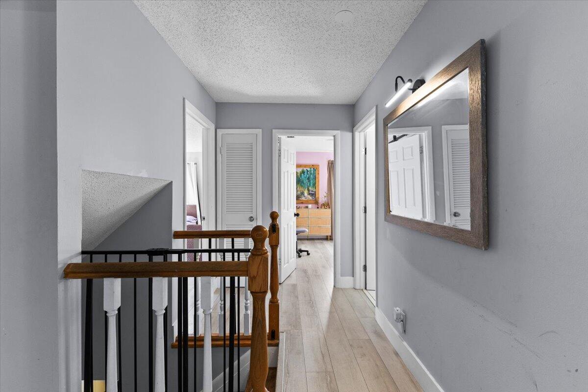3179 Hoy Lake Road Wellington, FL 33467 - Photo 17 of 43 a view of a hallway with wooden floor and staircase