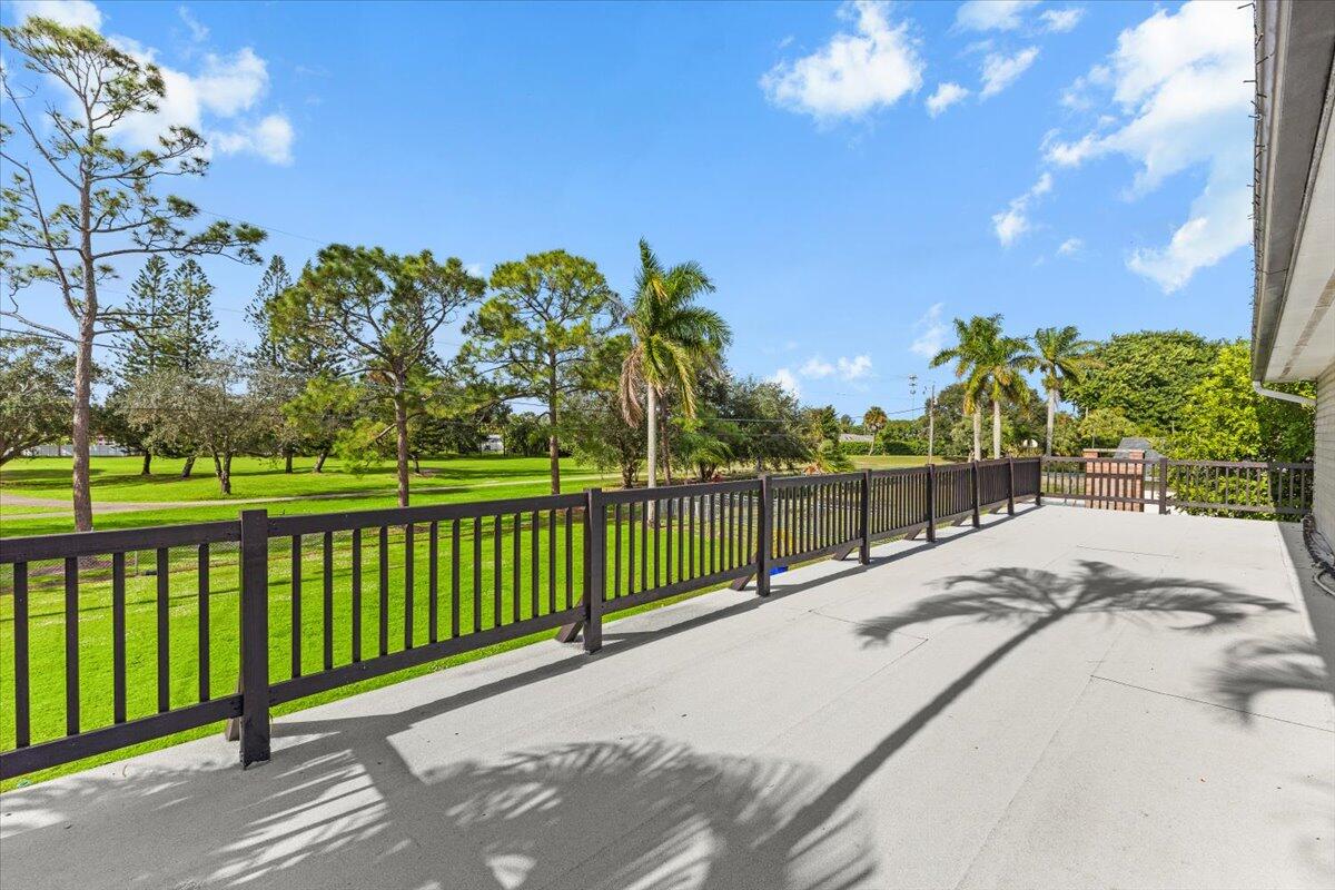 3179 Hoy Lake Road Wellington, FL 33467 - Photo 21 of 43 a view of a balcony with a yard