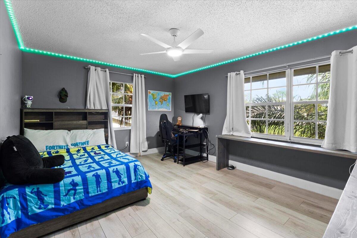 3179 Hoy Lake Road Wellington, FL 33467 - Photo 24 of 43 a bedroom with furniture and a large window