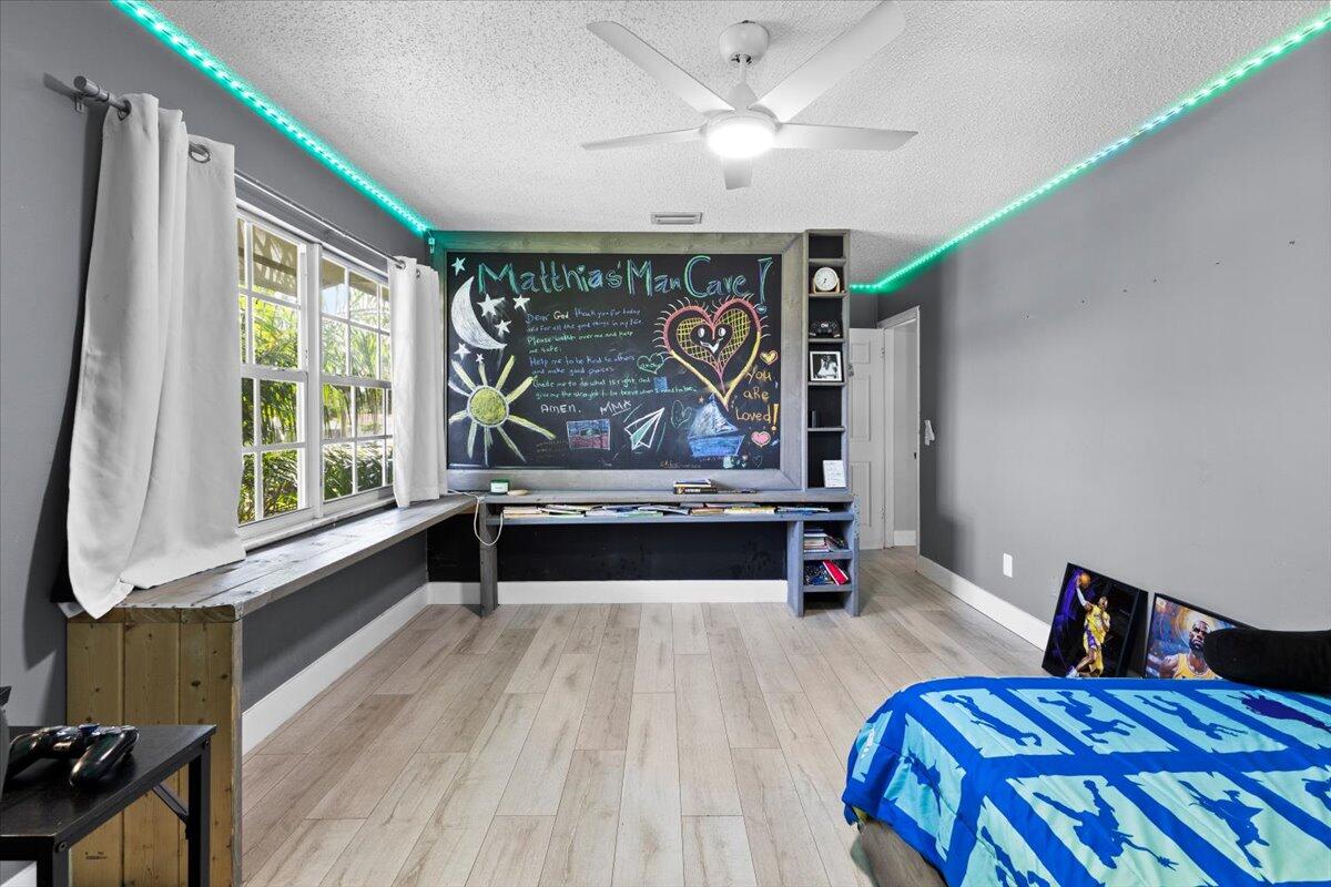 3179 Hoy Lake Road Wellington, FL 33467 - Photo 25 of 43 a bed room with a bed and a large window