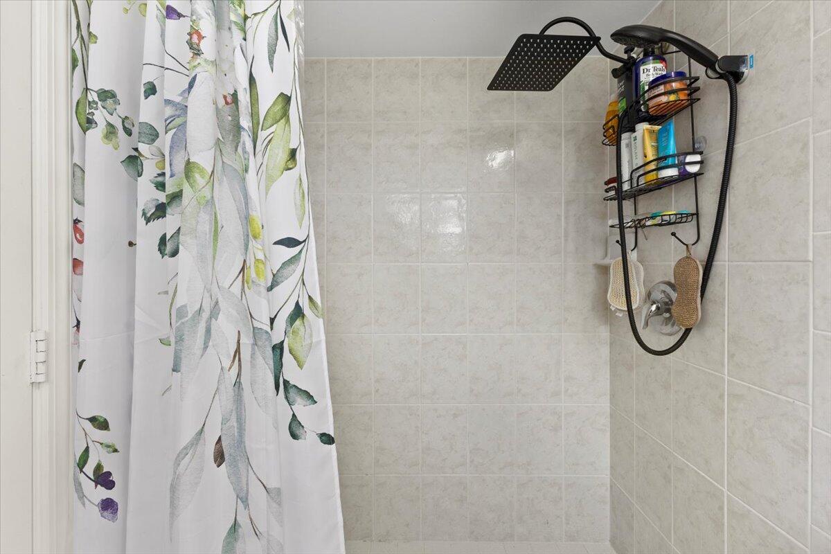 3179 Hoy Lake Road Wellington, FL 33467 - Photo 27 of 43 a bathroom with a shower curtain and a shower curtain