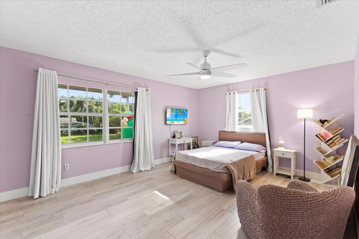 3179 Hoy Lake Road Wellington, FL 33467 - Photo 29 of 43 a bedroom with a bed and large window
