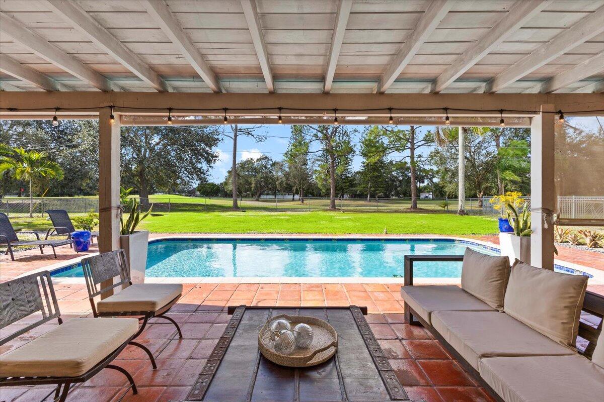 3179 Hoy Lake Road Wellington, FL 33467 - Photo 31 of 43 a swimming pool with outdoor seating and yard