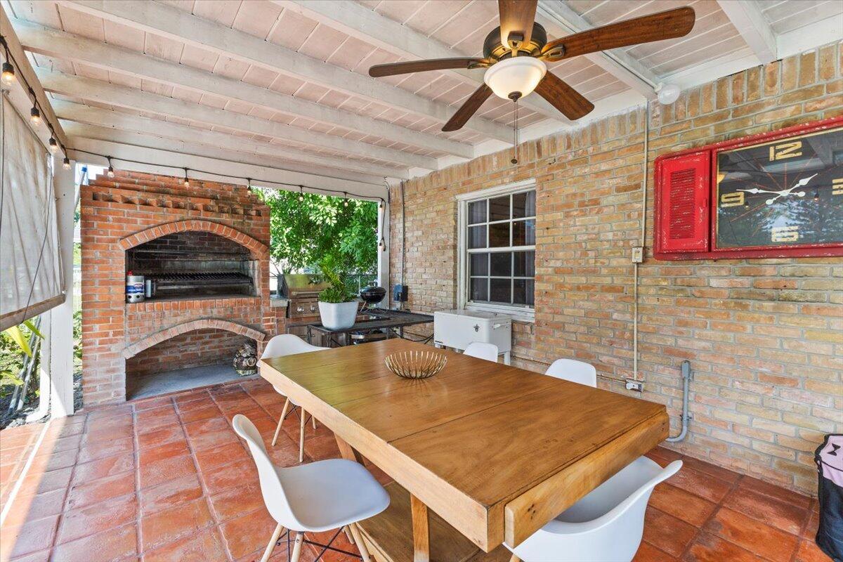 3179 Hoy Lake Road Wellington, FL 33467 - Photo 32 of 43 a living room with a couch and a chandelier