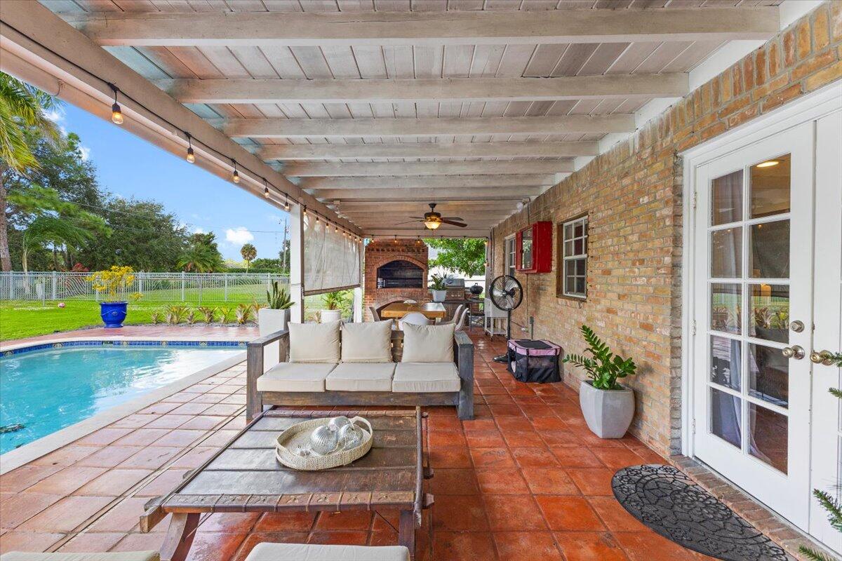 3179 Hoy Lake Road Wellington, FL 33467 - Photo 34 of 43 a living room with patio furniture and a garden