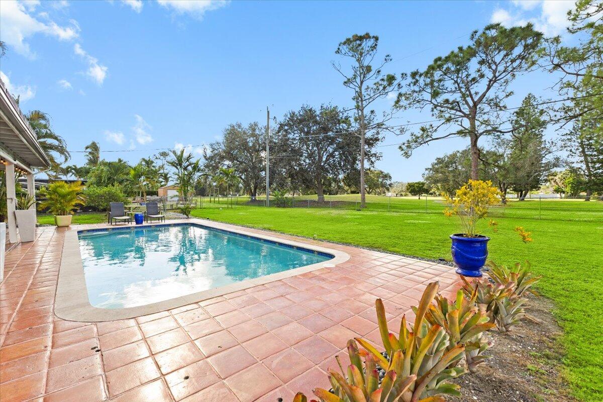3179 Hoy Lake Road Wellington, FL 33467 - Photo 35 of 43 a view of a swimming pool with a patio