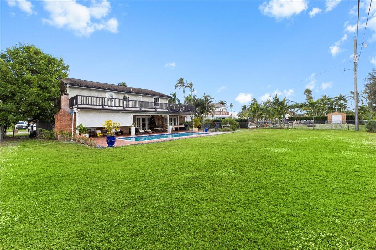 3179 Hoy Lake Road Wellington, FL 33467 - Photo 37 of 43 a front view of a house with a garden
