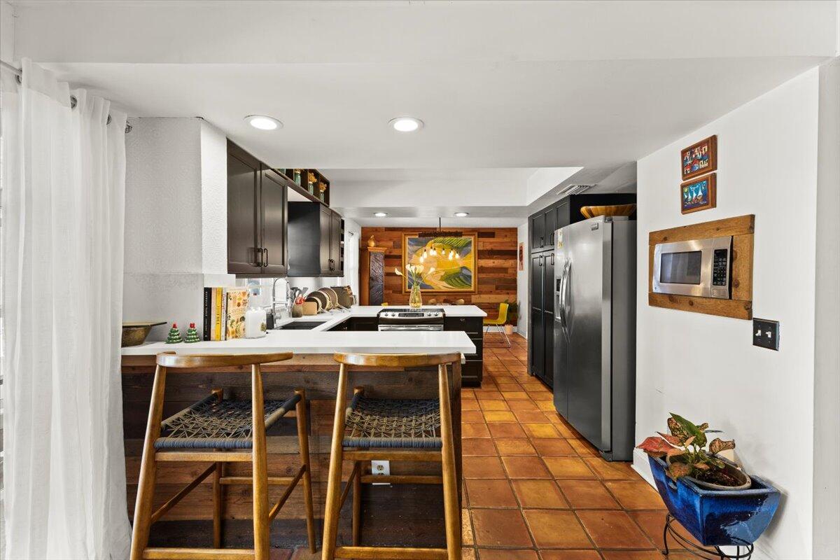 3179 Hoy Lake Road Wellington, FL 33467 - Photo 8 of 43 a kitchen with stainless steel appliances granite countertop a stove and a refrigerator