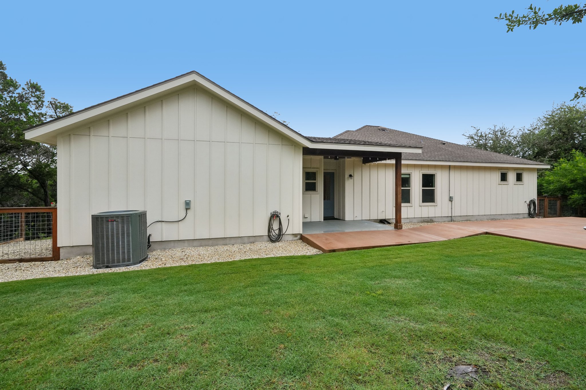 190 Magnolia Meadow Spring Branch, TX 78070 - Photo 17 of 29 A neatly manicured lawn extends to a spacious concrete patio with a covered area.