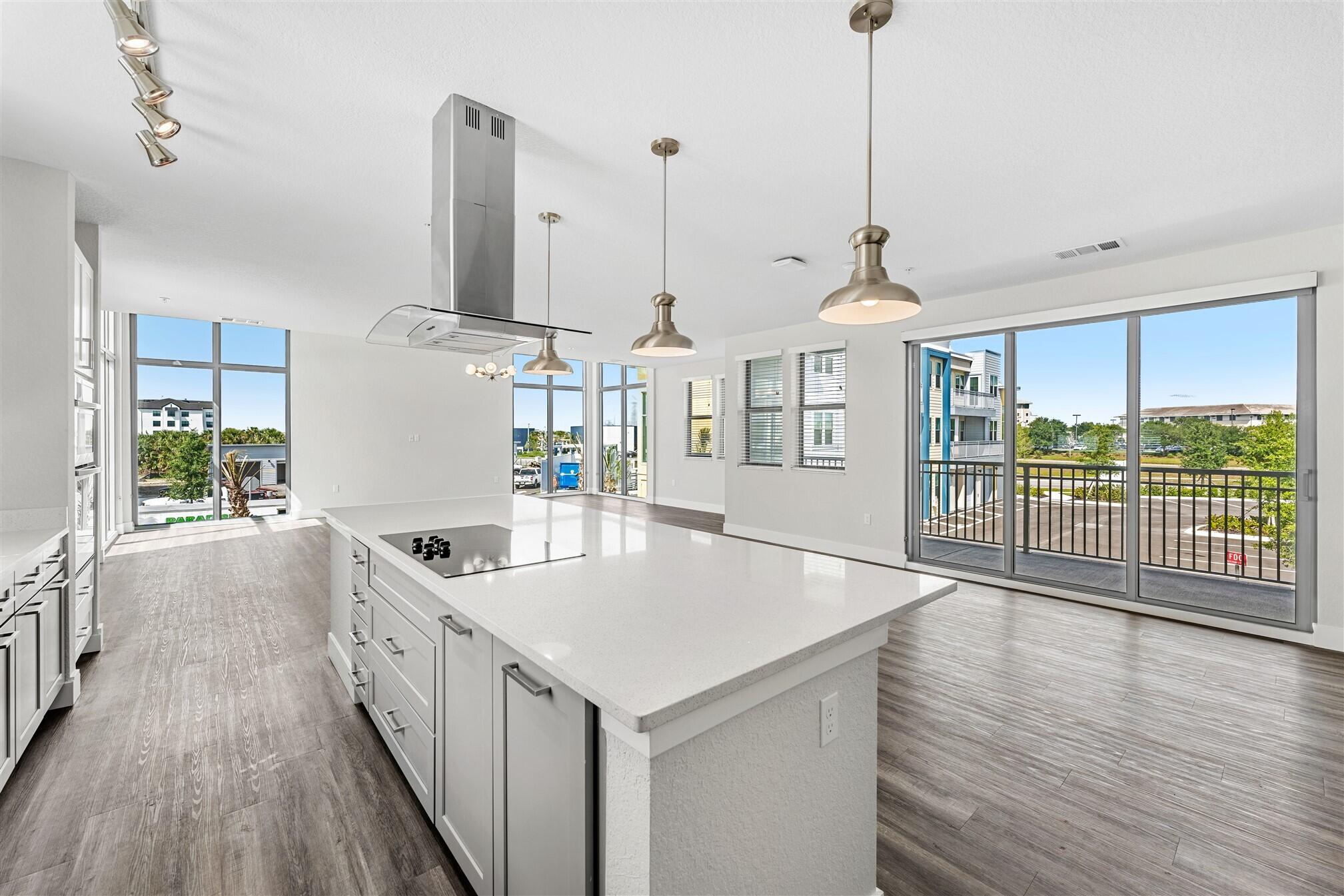 8663 Ivanhoe Drive Melbourne, FL 32940 - Photo 15 of 36 a kitchen with stainless steel appliances granite countertop a sink a microwave oven and a wooden floor