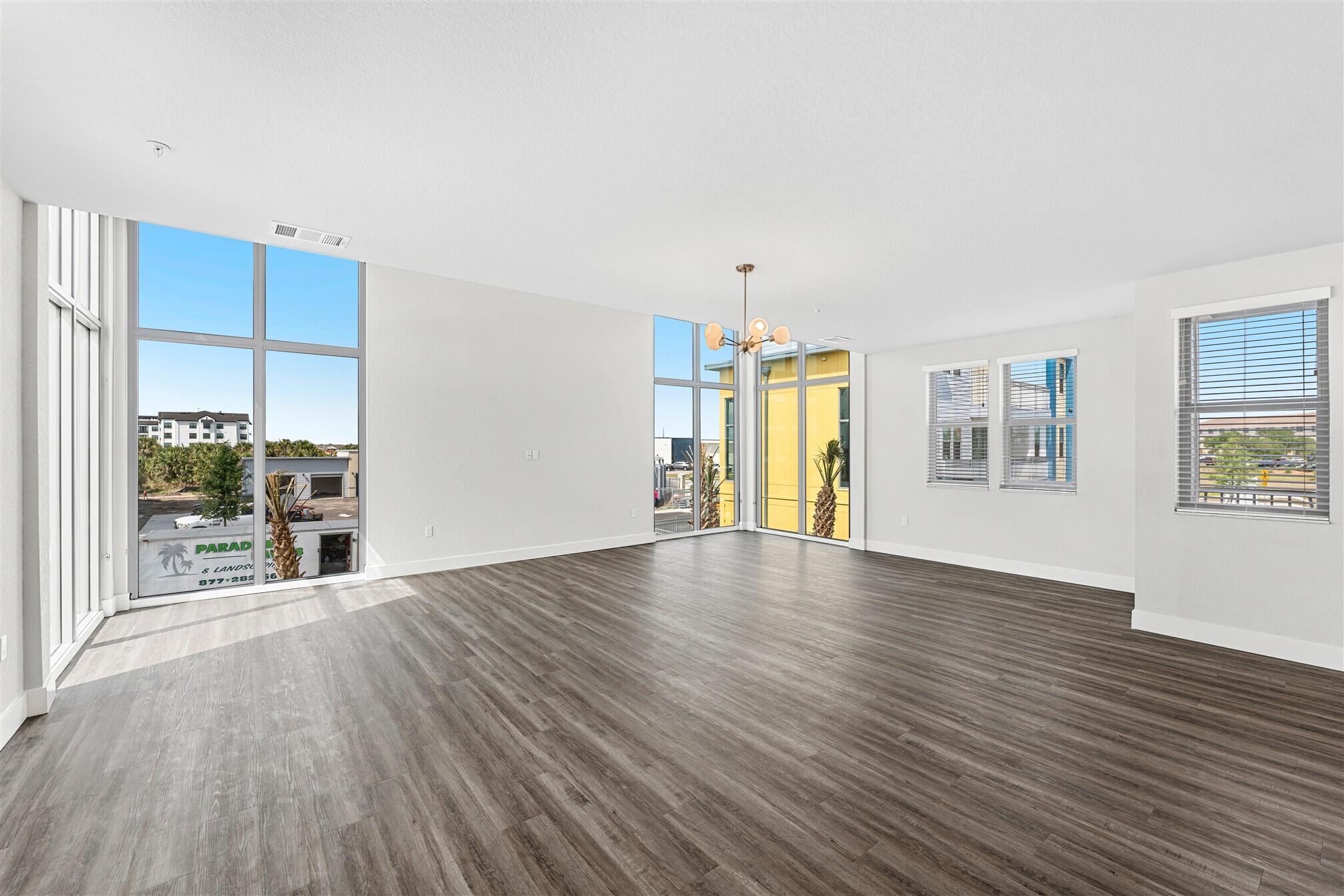 8663 Ivanhoe Drive Melbourne, FL 32940 - Photo 20 of 36 a view of an empty room with a window and wooden floor