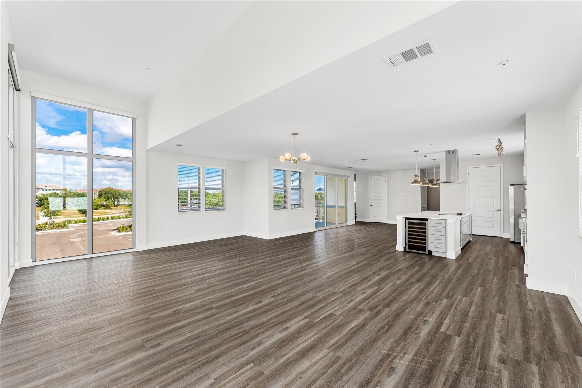 8663 Ivanhoe Drive Melbourne, FL 32940 - Photo 21 of 36 a view of empty room with wooden floor and windows
