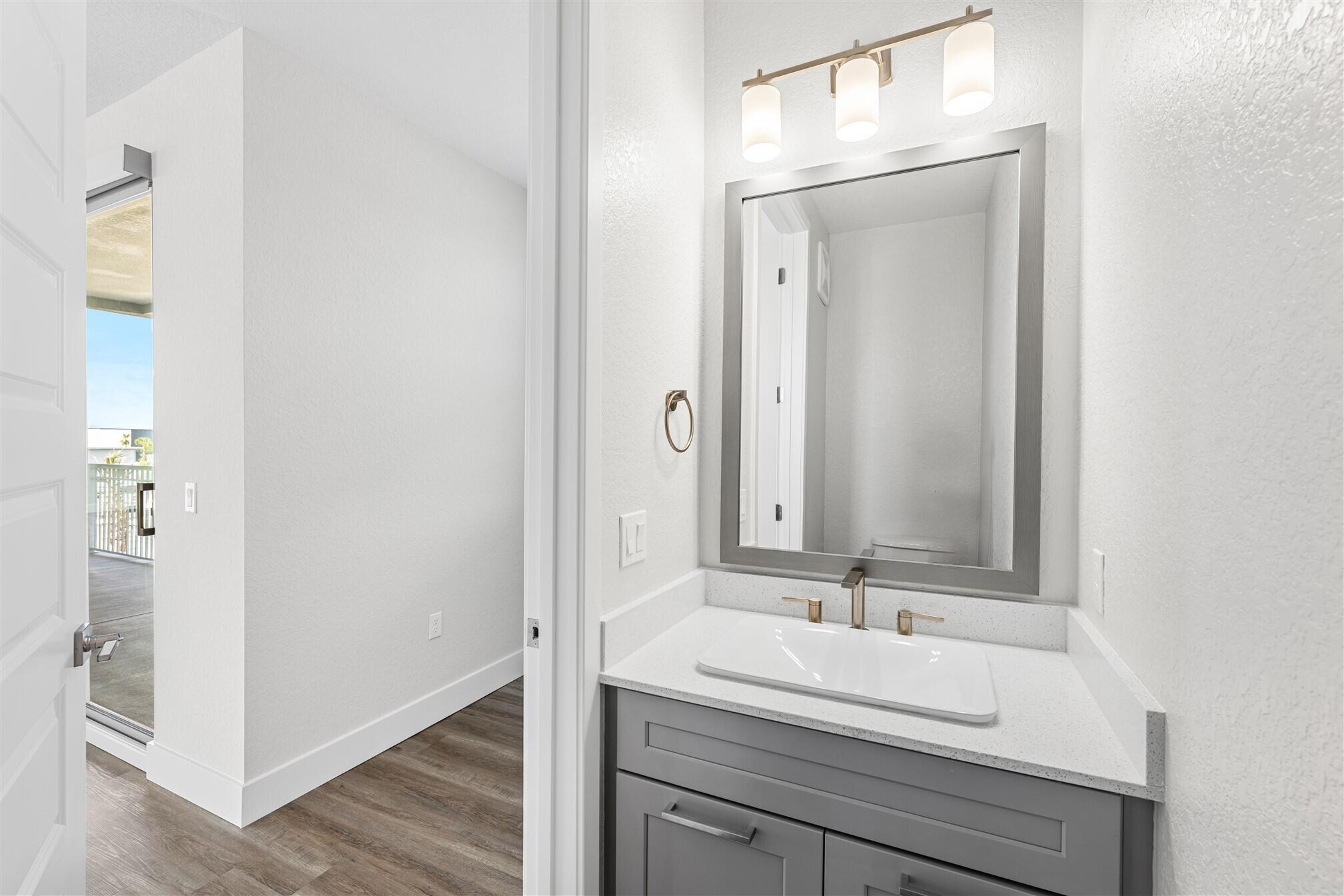 8663 Ivanhoe Drive Melbourne, FL 32940 - Photo 25 of 36 a bathroom with a sink and a mirror