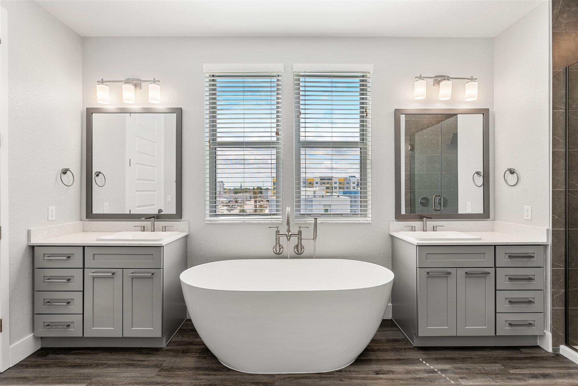 8663 Ivanhoe Drive Melbourne, FL 32940 - Photo 30 of 36 a spacious bathroom with a granite countertop tub sink and mirror