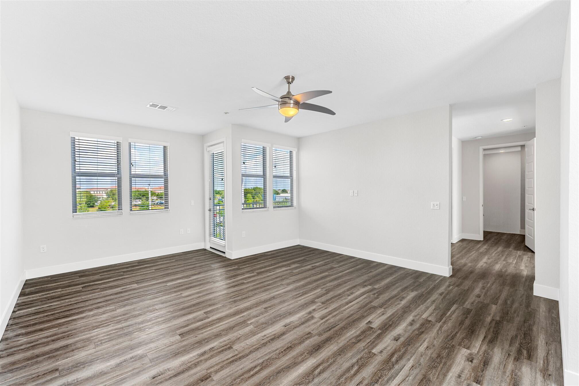 8663 Ivanhoe Drive Melbourne, FL 32940 - Photo 33 of 36 a view of an empty room with window and wooden floor