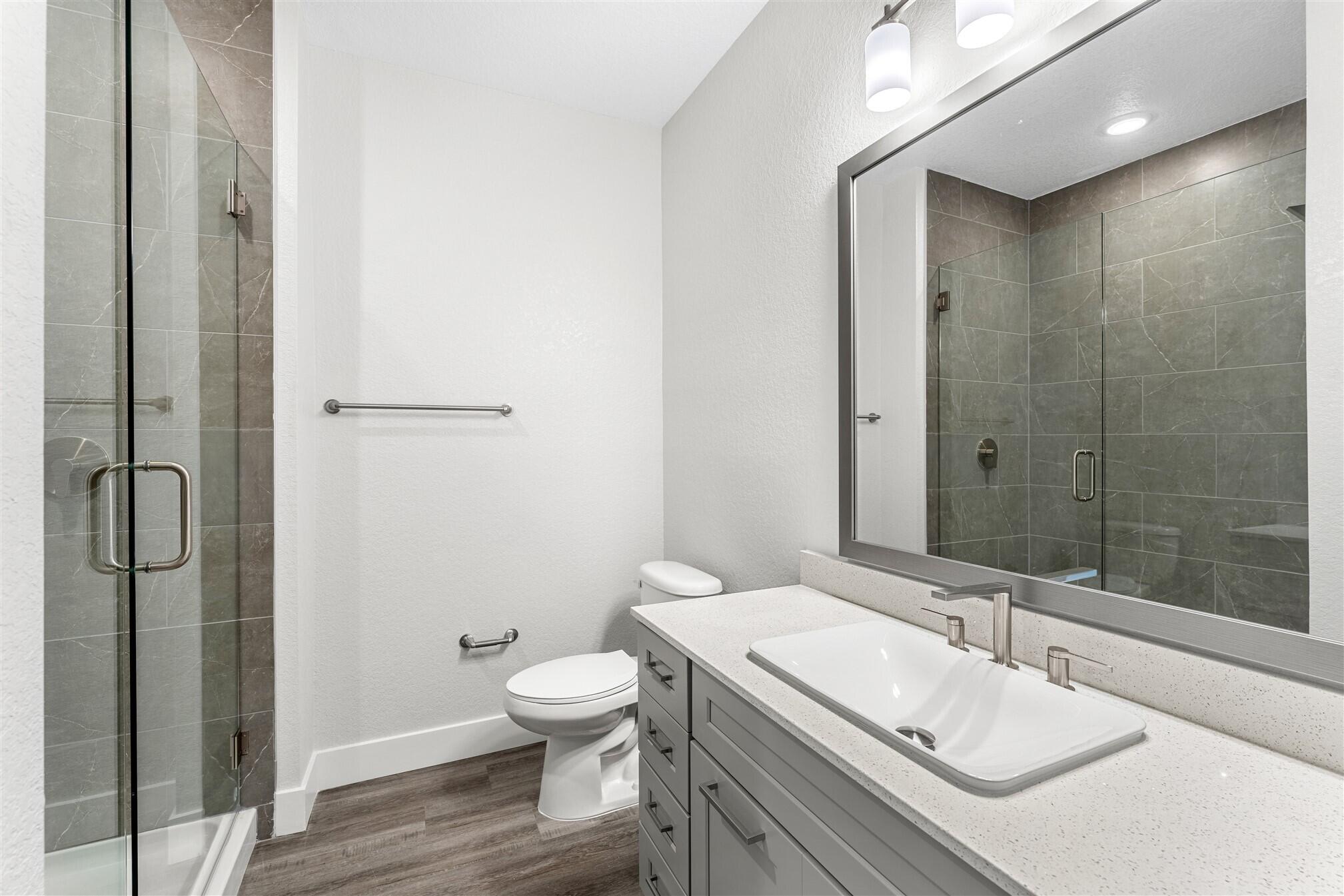 8663 Ivanhoe Drive Melbourne, FL 32940 - Photo 9 of 36 a bathroom with a sink toilet and shower