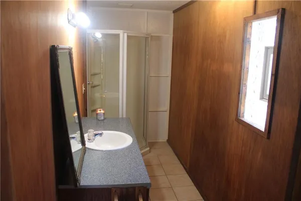 a bathroom with a sink a mirror and a shower