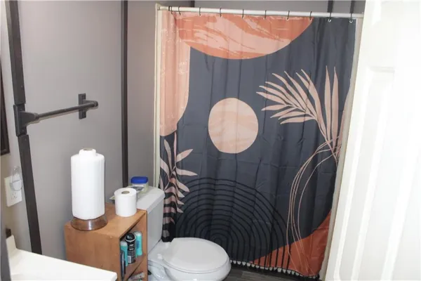 a bathroom with a sink mirror vanity and toilet