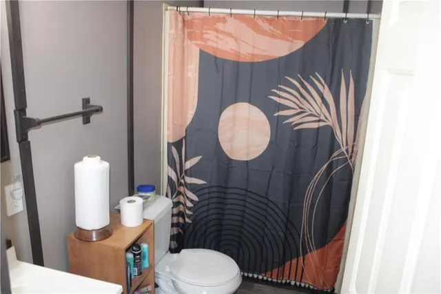 a bathroom with a sink mirror vanity and toilet