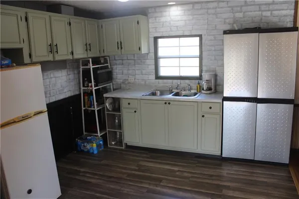 a room with wooden floor and windows