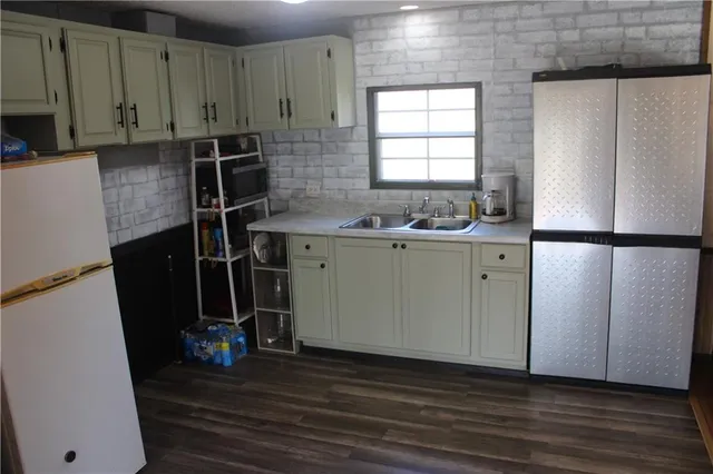 a room with wooden floor and windows