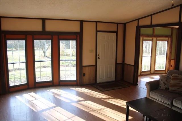 a view of a livingroom with a couch and a large window