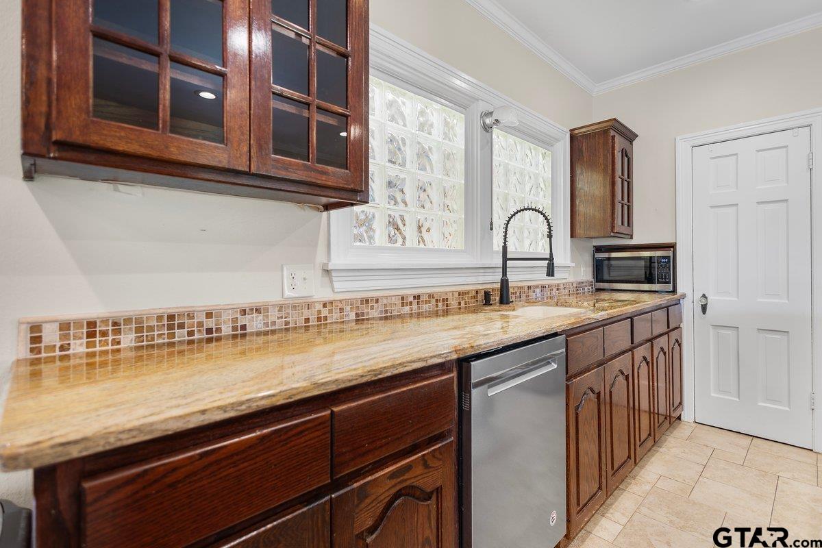 a kitchen with stainless steel appliances granite countertop a sink and cabinets