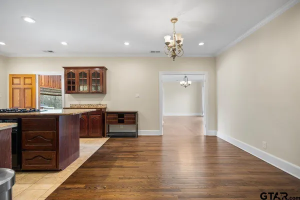 a large kitchen with stainless steel appliances wooden floors and wooden cabinets