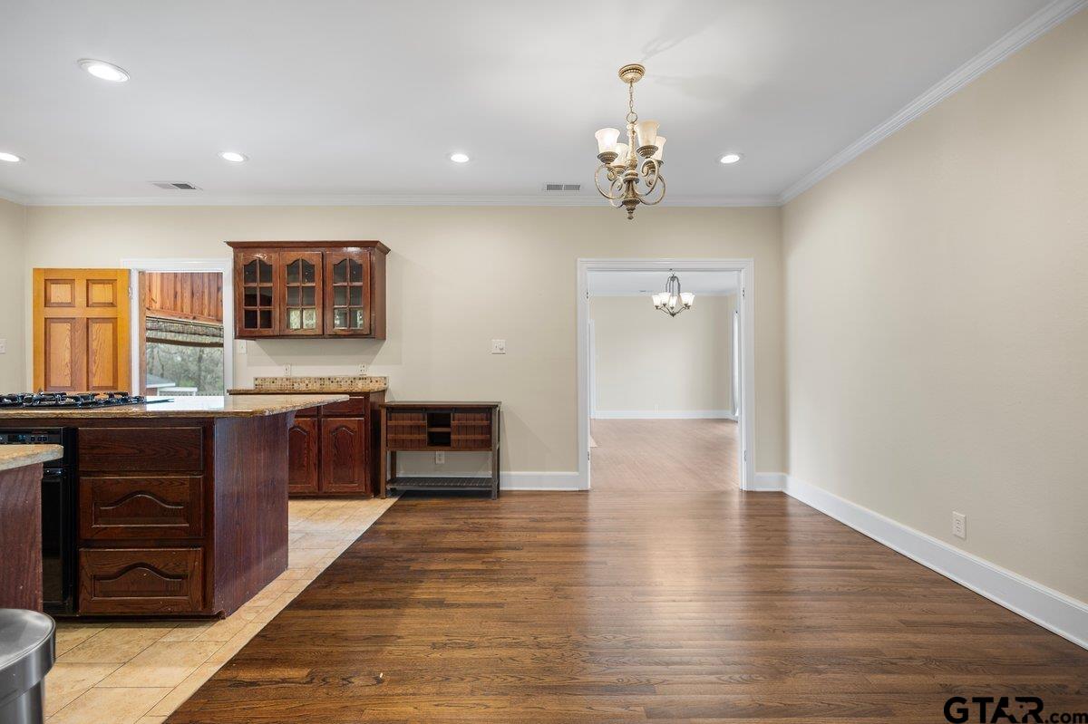 1609 Old Nacogdoches Road Henderson, TX 75654 - Photo 11 of 48 a large kitchen with stainless steel appliances a large counter top a stove and a refrigerator