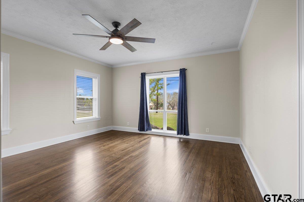 1609 Old Nacogdoches Road Henderson, TX 75654 - Photo 15 of 48 an empty room with wooden floor fan and windows
