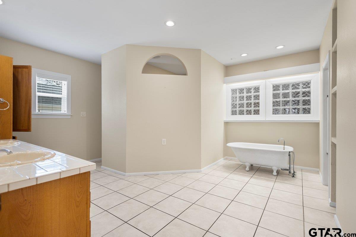 1609 Old Nacogdoches Road Henderson, TX 75654 - Photo 24 of 48 a bathroom with a sink a toilet and a window