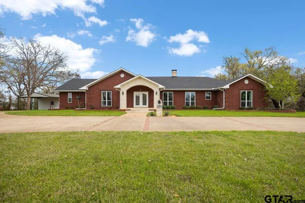 a front view of house with yard and green space