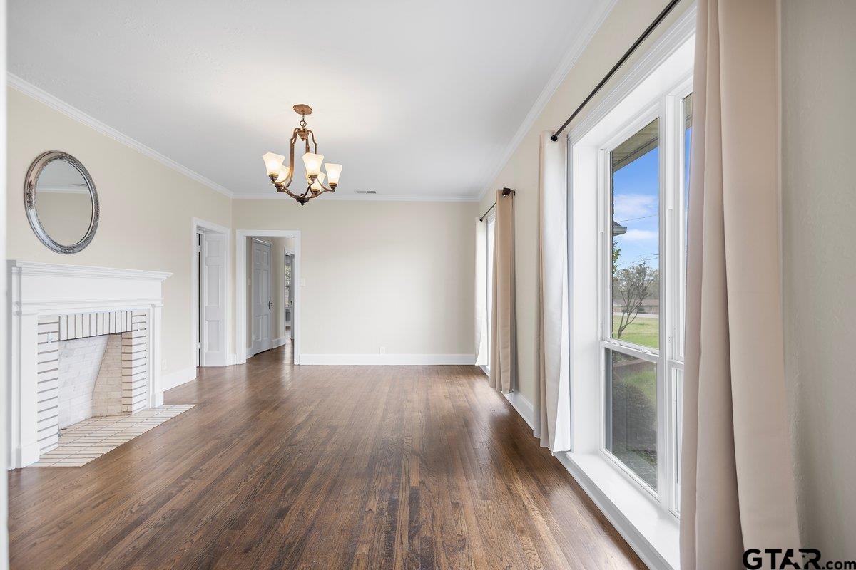 1609 Old Nacogdoches Road Henderson, TX 75654 - Photo 7 of 48 a view of a livingroom with wooden floor and a ceiling fan