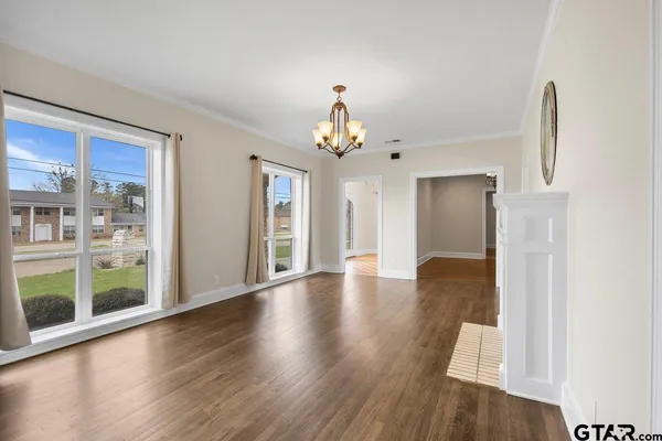 a view of a large room with wooden floor and windows