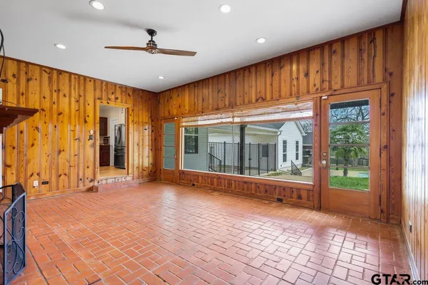 a view of an empty room with a fireplace and a window