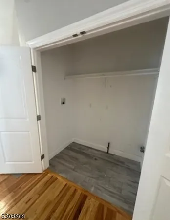 a view of a room with wooden floor and cabinet