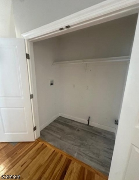 474 10th Avenue, Unit 303 Paterson, NJ 07514 - Photo 6 of 13 a view of a room with wooden floor and cabinet