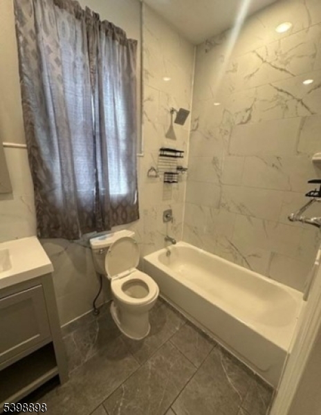 474 10th Avenue, Unit 303 Paterson, NJ 07514 - Photo 8 of 13 a bath room with a sink and a toilet