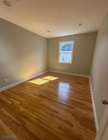 a view of room with wooden floor