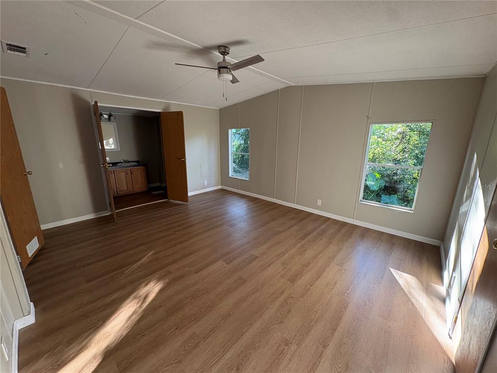 28492 Sentinel Street Nobleton, FL 34661 - Photo 13 of 23 wooden floor in an empty room with a window