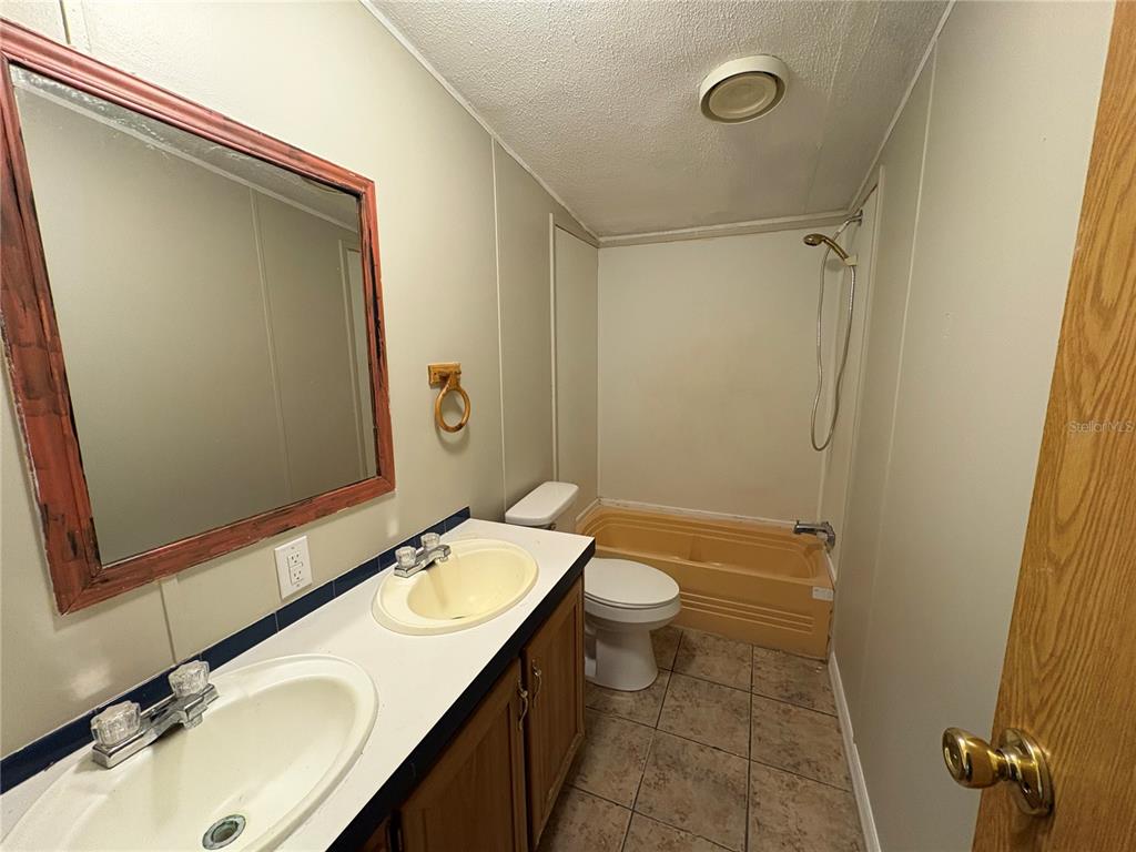 28492 Sentinel Street Nobleton, FL 34661 - Photo 19 of 23 a bathroom with a sink and mirror with toilet