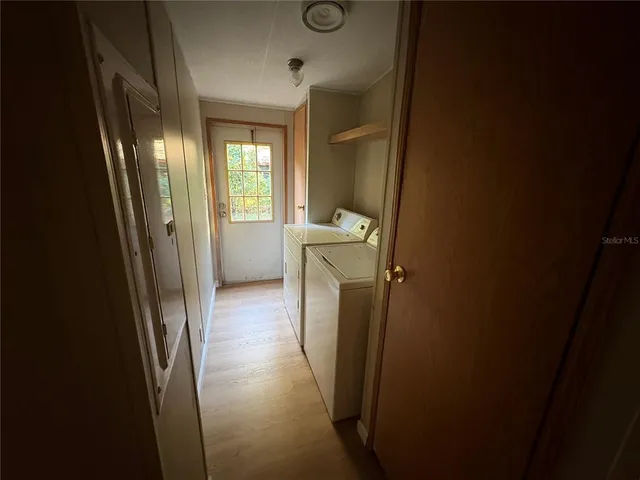 a view of a bathroom from a corridor