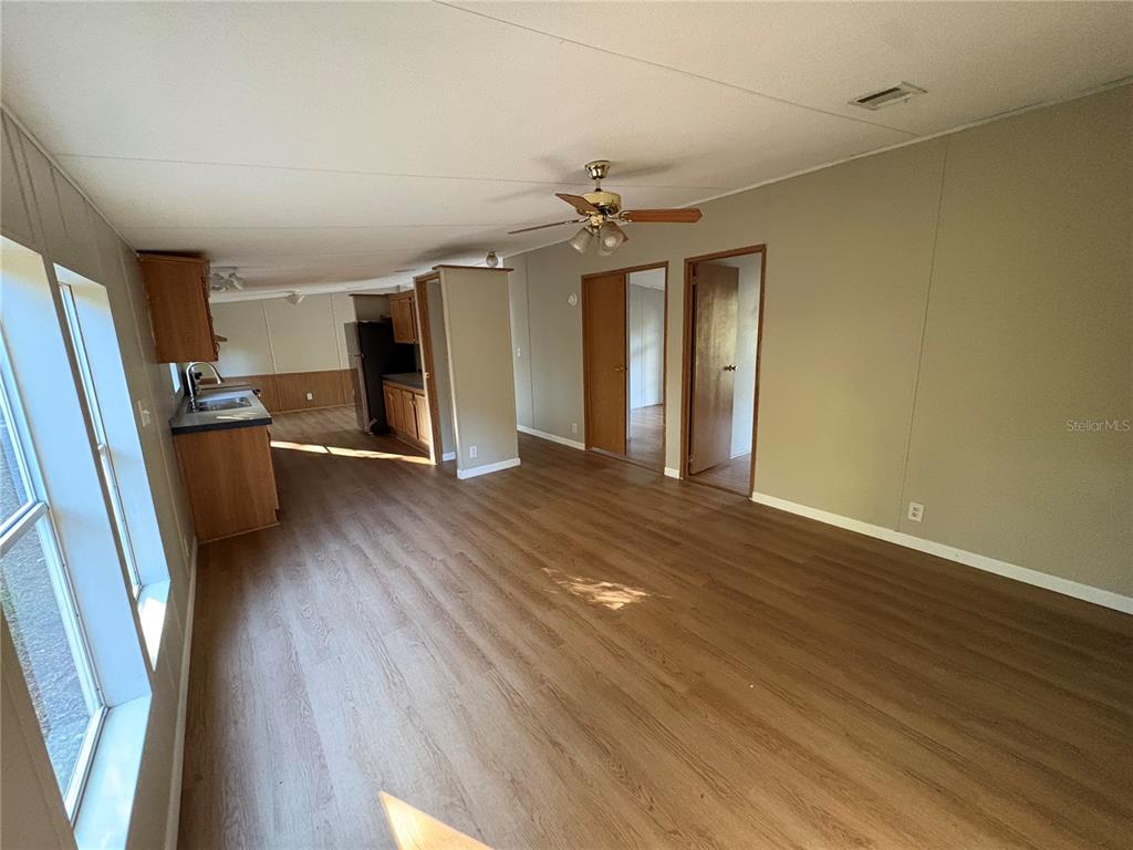 28492 Sentinel Street Nobleton, FL 34661 - Photo 7 of 23 wooden floor in an empty room with a window