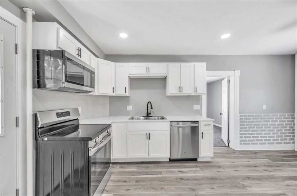 248 Parker Street Springfield, MA 01151 - Photo 7 of 26 a kitchen with stainless steel appliances granite countertop a sink stove and refrigerator